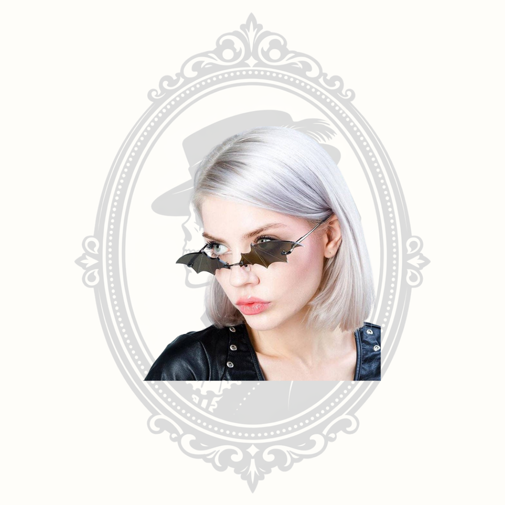 Model wearing black bat wing novelty sunglasses with gothic-inspired design.
