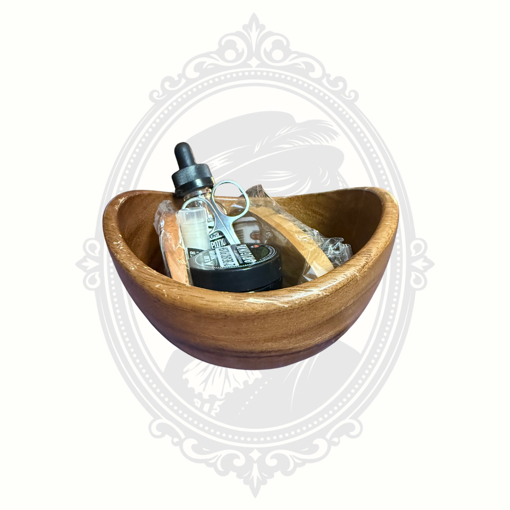 Beard grooming gift set arranged in a rustic wooden bowl with brush, comb, scissors, and beard care products