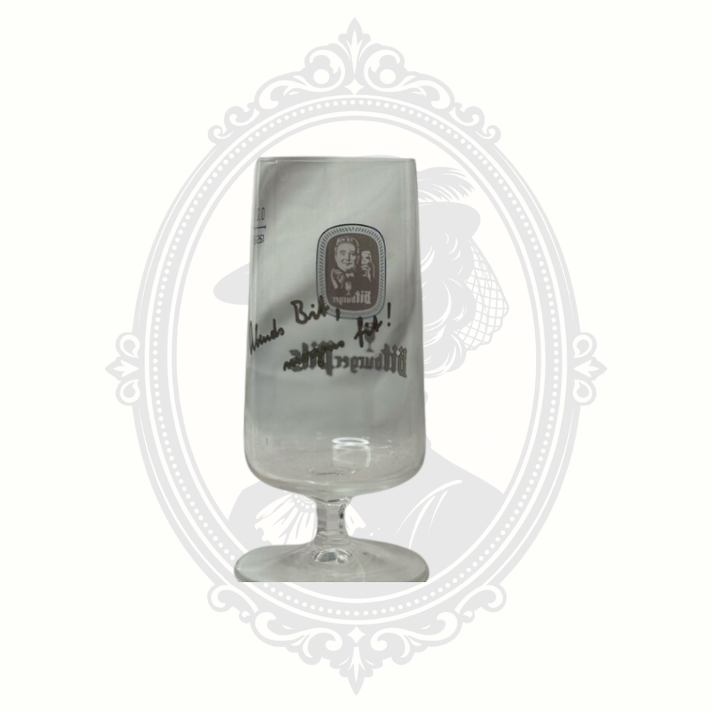 Angled logo view of Bitburger pils beer glass with classic German brewery branding.