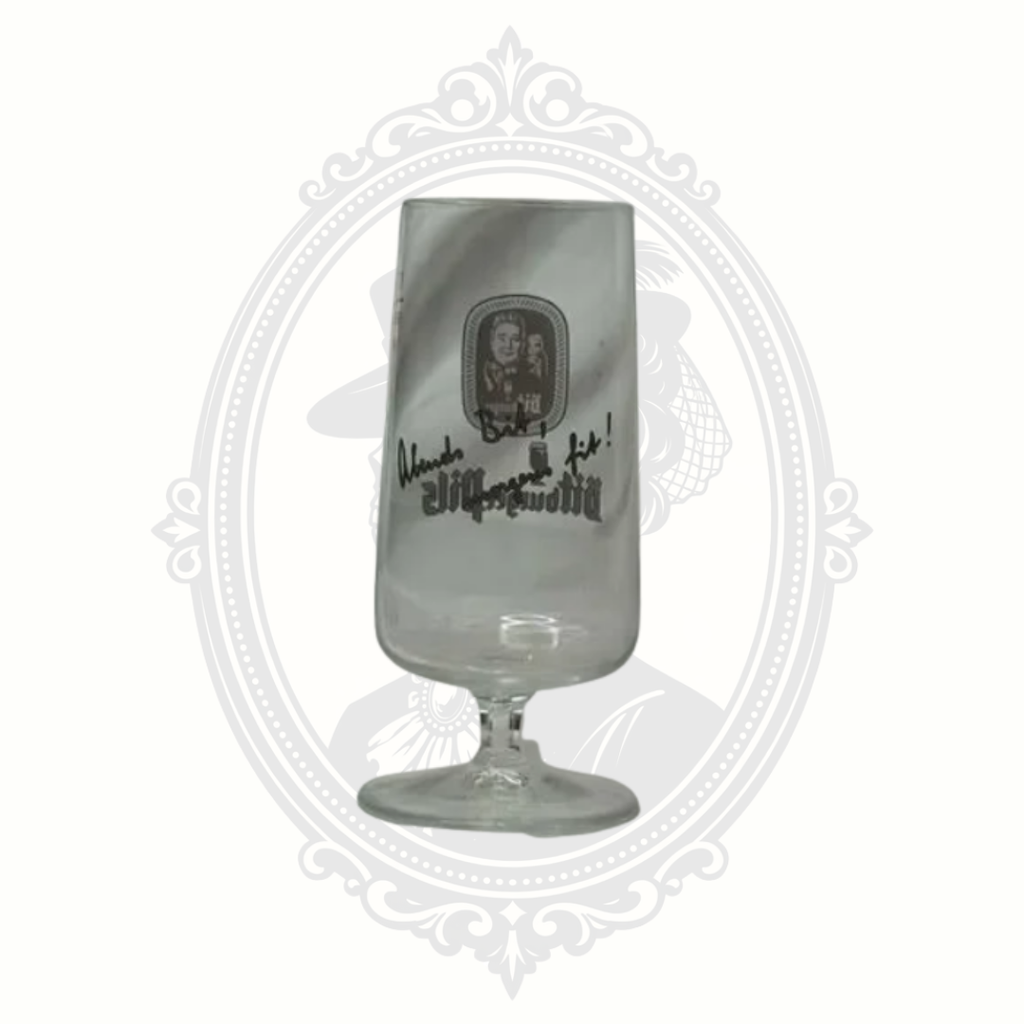 Front view of Bitburger pils glass photographed in brighter lighting to show clarity and logo detail.