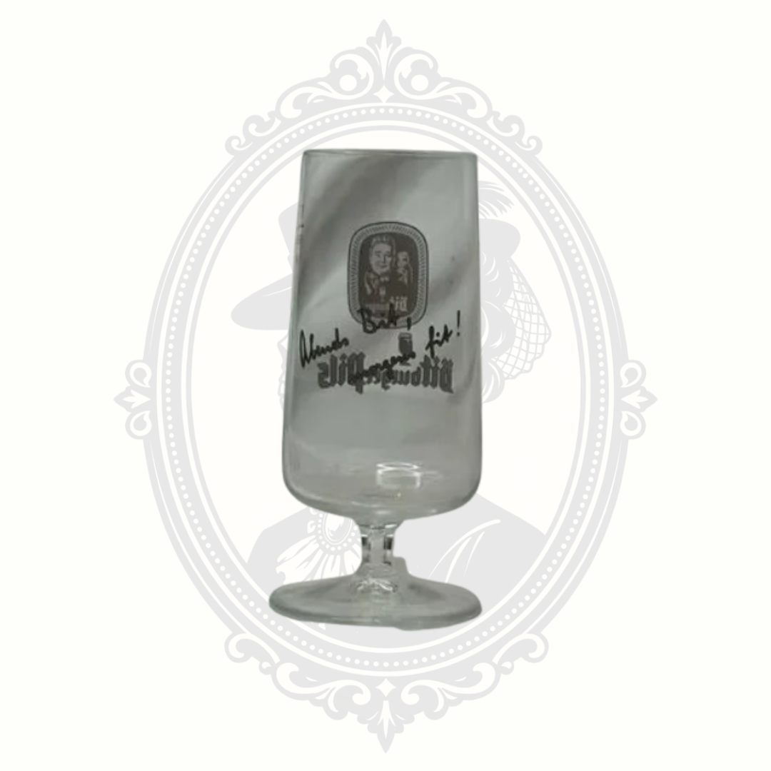 Front view of Bitburger pils glass photographed in brighter lighting to show clarity and logo detail.