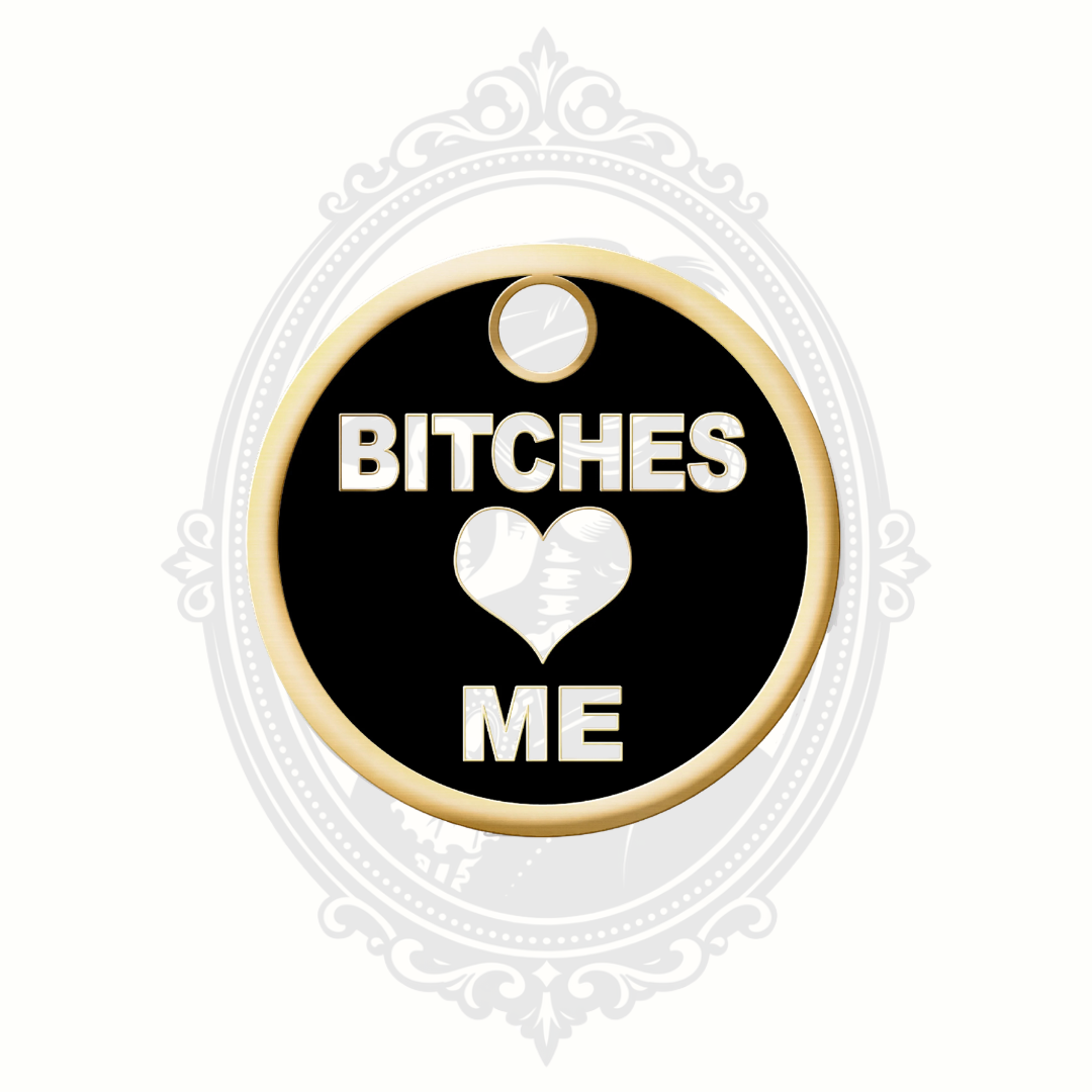Black novelty pet tag with gold-tone trim and the phrase “Bitches Love Me.”