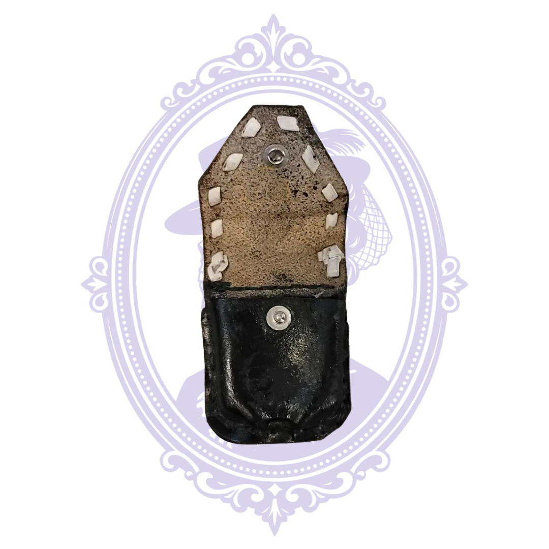 Front of black leather mini pouch with white lacing and snap