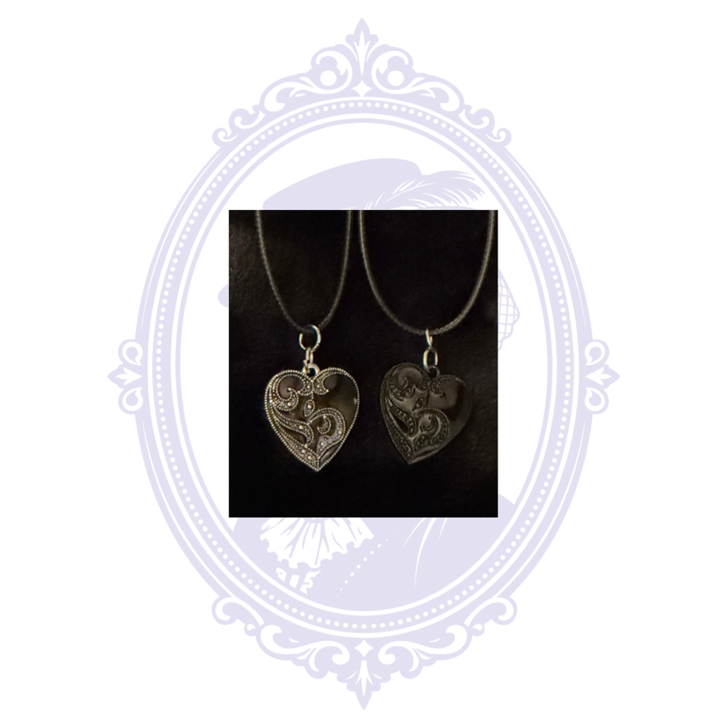 Black-on-black and silver-on-black ornate heart gothic necklace variants on black cords.