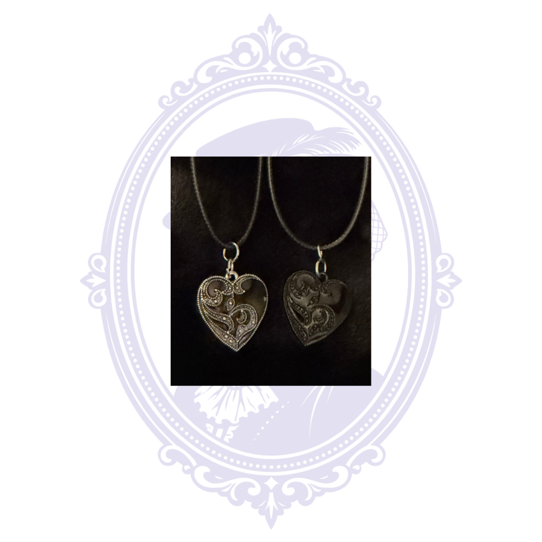 Black-on-black and silver-on-black ornate heart gothic necklace variants on black cords.