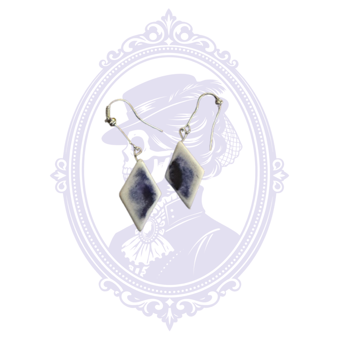 Back view of blue and white diamond-shaped dangle earrings showing the coordinating reverse finish.