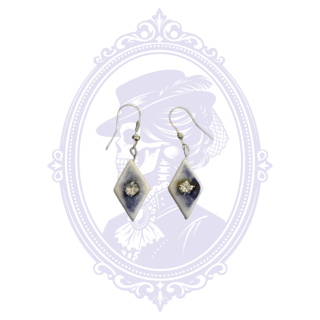 Full front view of pre-owned blue and white diamond dangle earrings with silver-tone hooks.