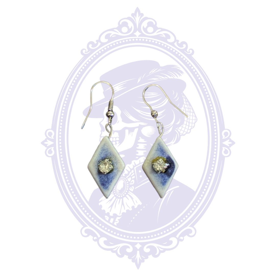 Blue and white diamond-shaped dangle earrings with clear rhinestone centers and silver-tone fishhook ear wires.
