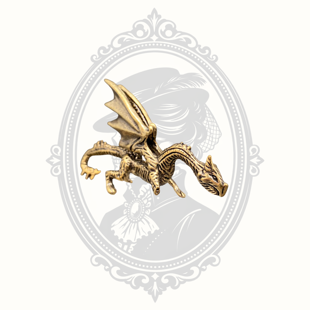 Left side view of the miniature brass dragon ornament showing detailed wings and scales.
