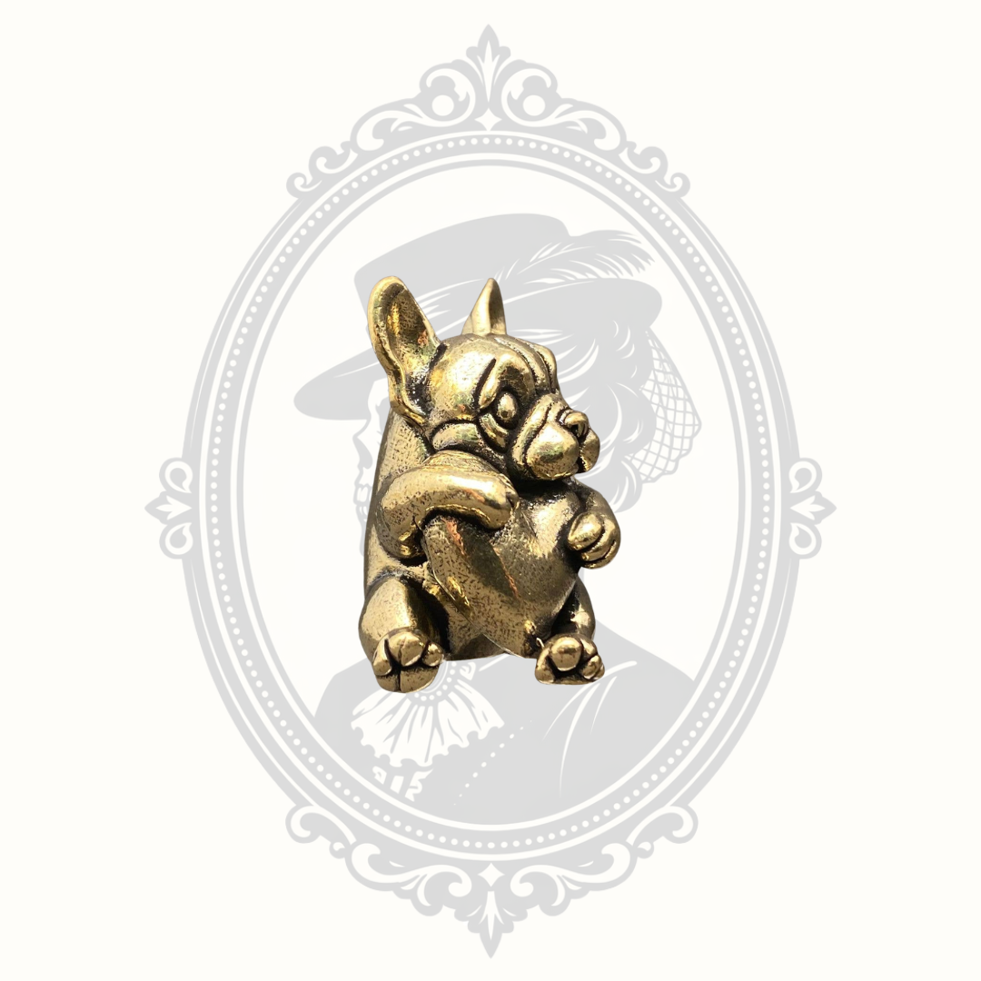 Angled view of a miniature solid brass French Bulldog figurine holding a heart.