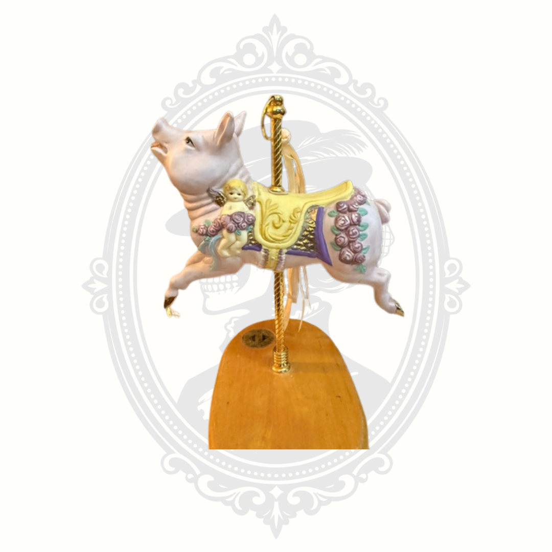 Side profile of Breckenridge carousel pig collectible with decorative floral and ribbon embellishments.