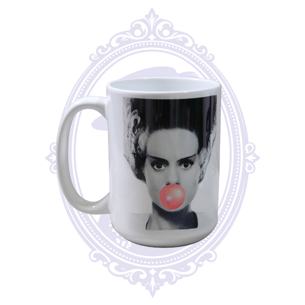 Bride of Frankenstein blowing a pink bubblegum bubble on a white classic horror ceramic mug.