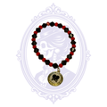 Red and black faceted glass bead stretch bracelet with gold-tone broken heart and crossbones alphabet charm.