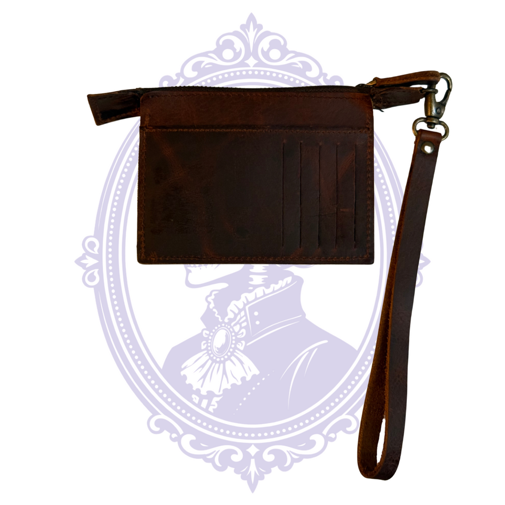 Open zip compartment of brown leather wristlet wallet showing unlined leather interior