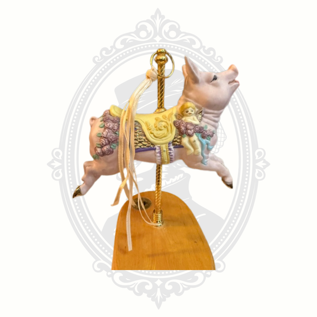 Close-up detail of carousel pig figurine ribbon accents on vintage-inspired decorative music box.