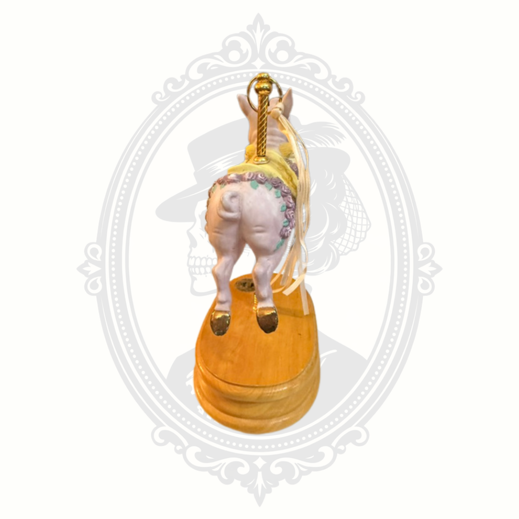 Side view of carousel pig music box collectible with decorative painted accents and nostalgic charm.
