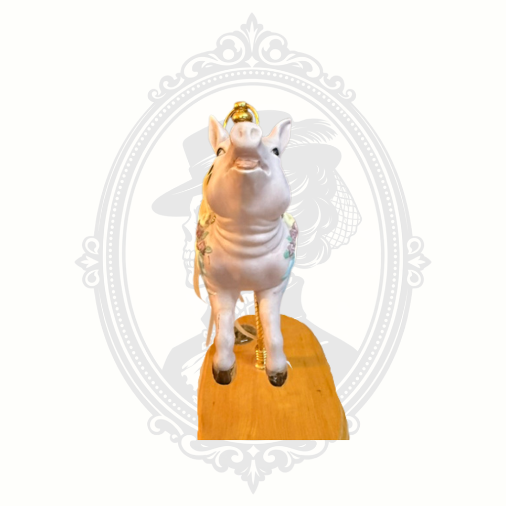 Front view of carousel pig music box collectible with ornate painted details and whimsical carnival aesthetic.