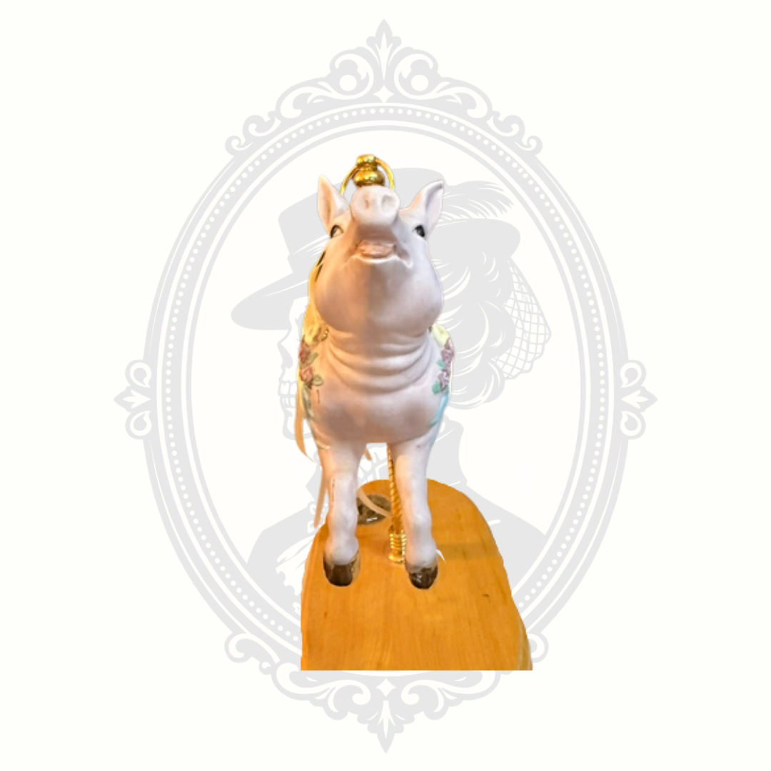 Front view of carousel pig music box collectible with ornate painted details and whimsical carnival aesthetic.