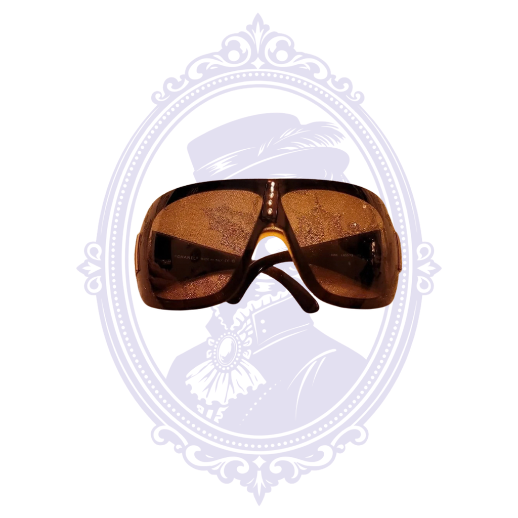 Interior view of Chanel 5086 brown shield sunglasses showing lenses and arms
