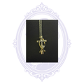 Front view of a Christian cross and Ichthys fish pendant necklace with a clear crystal accent, shown on its chain against a black background.