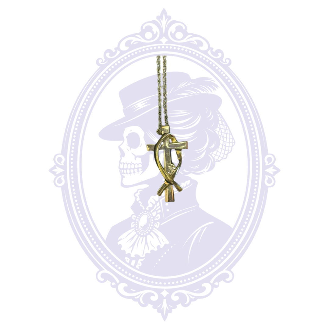 Full front view of a Christian cross and Ichthys fish pendant necklace with a clear crystal accent, displayed on a chain against the Mrs. Bones Curio Cupboard background.
