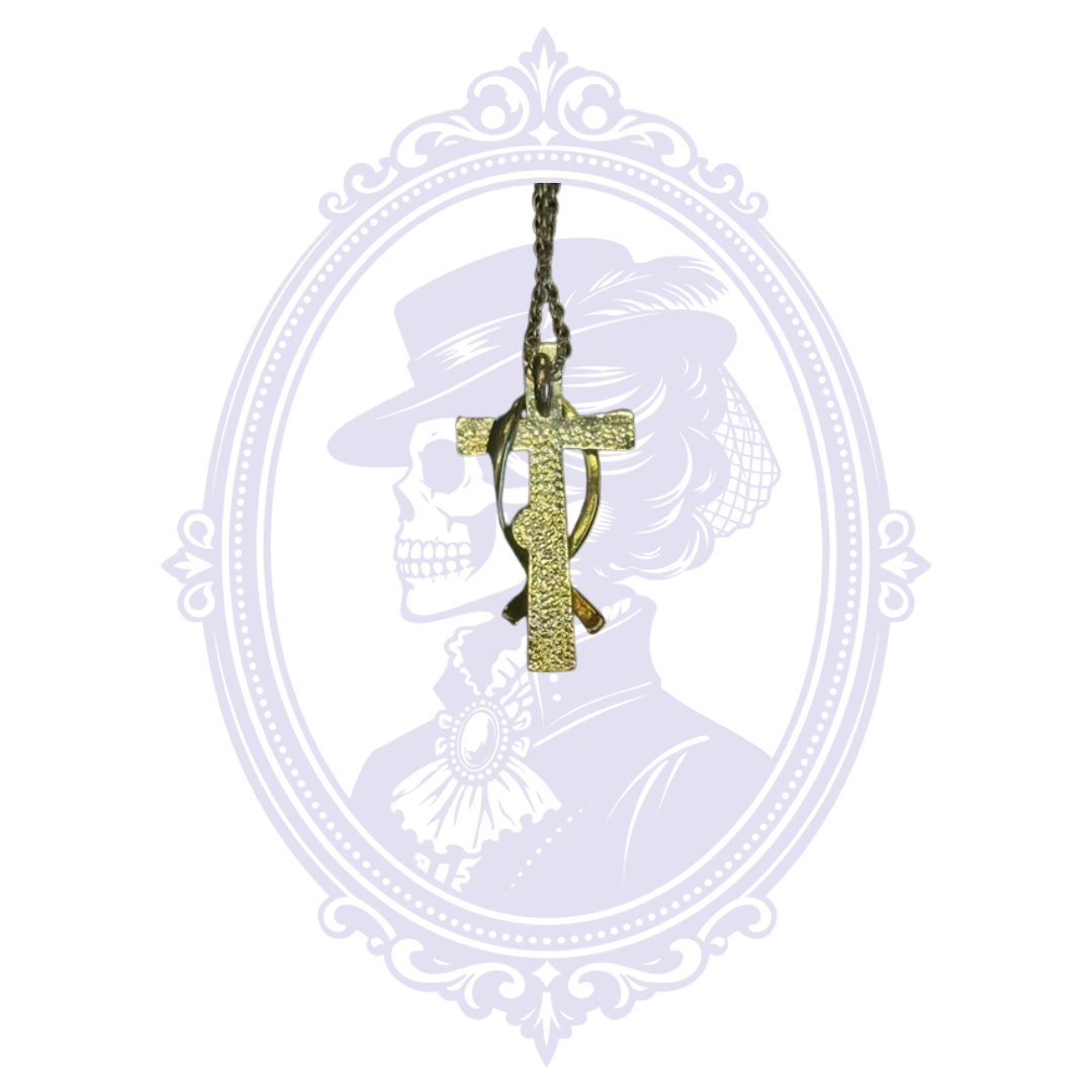 Close-up back view of a Christian cross and Ichthys fish pendant necklace showing the textured metal finish and chain.
