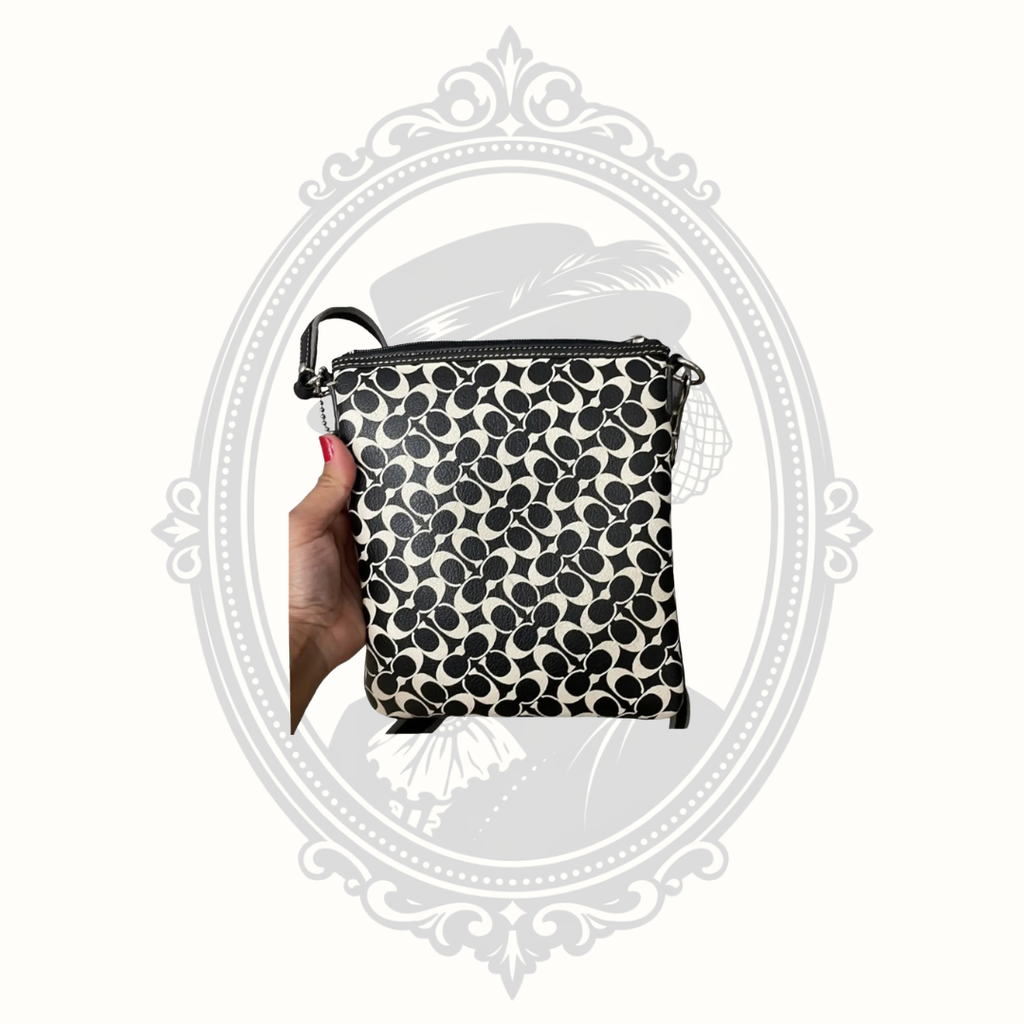 Back of Coach black and white signature crossbody bag