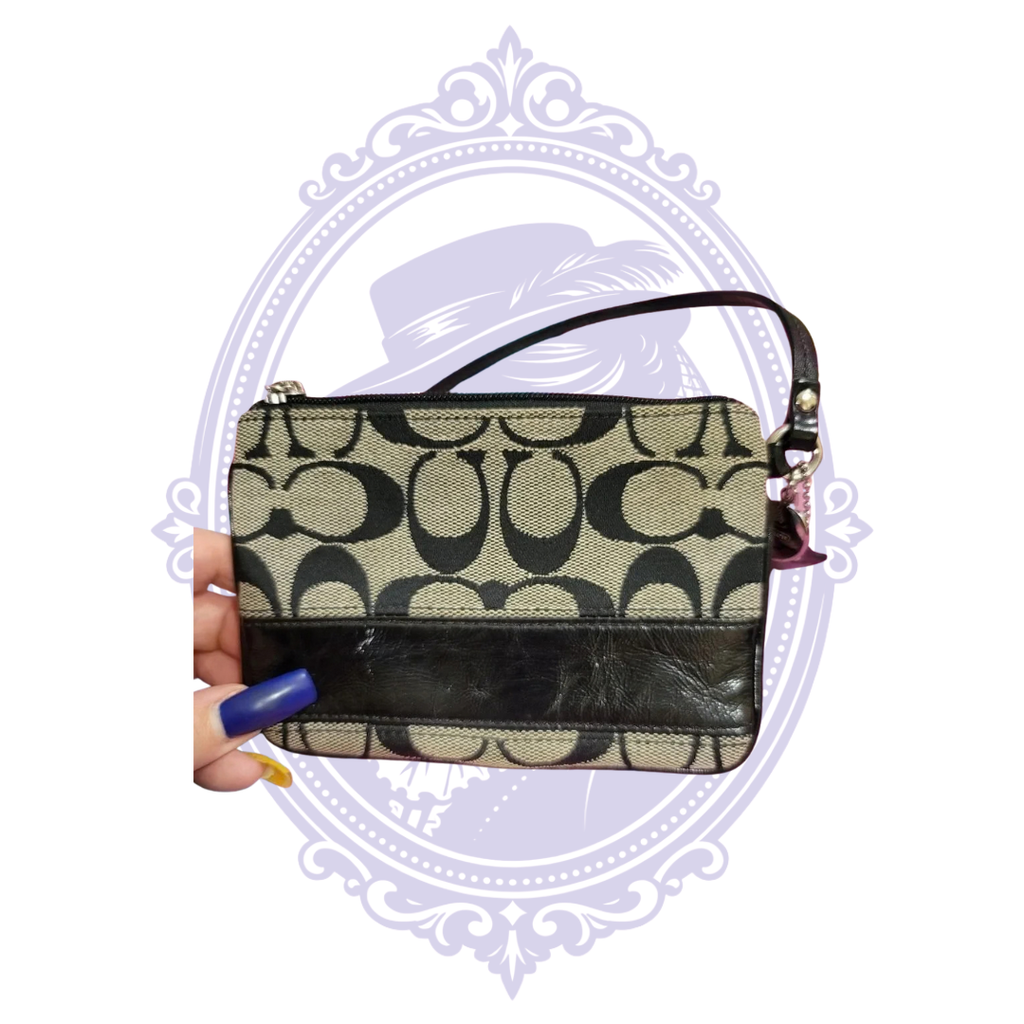 Close-up of Coach Signature C jacquard fabric and black leather stripe