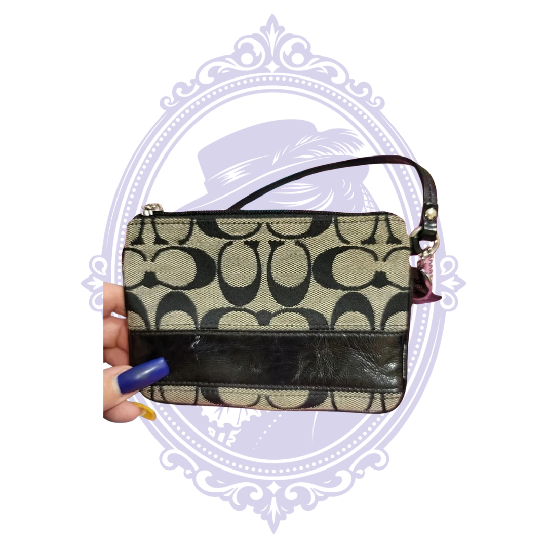 Close-up of Coach Signature C jacquard fabric and black leather stripe