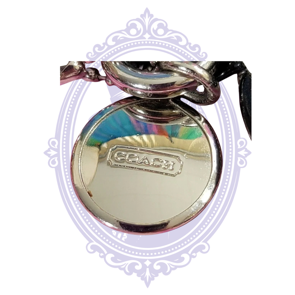 Coach Signature C black and tan wristlet, front view