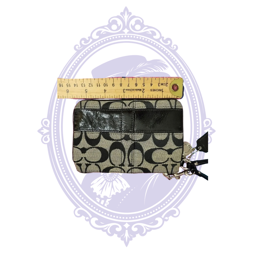 Coach wristlet next to ruler showing approximate height