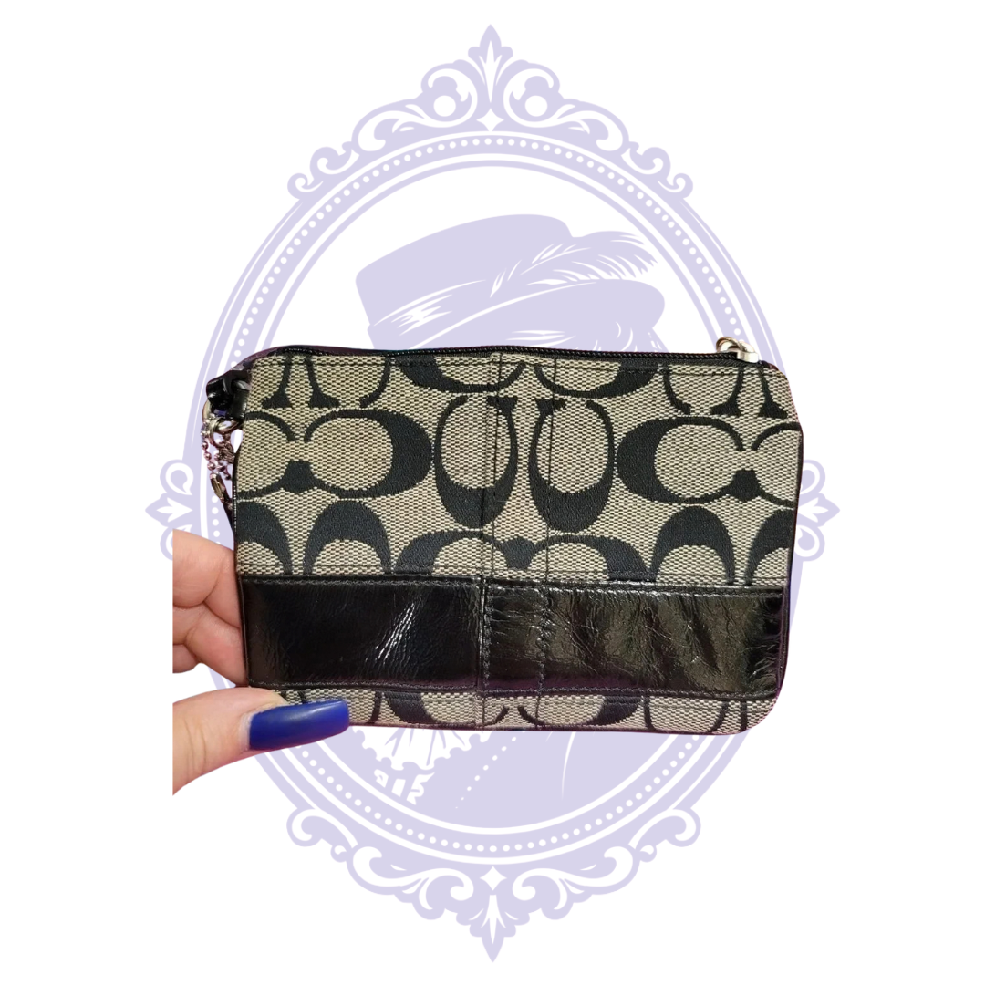 Coach round silver-tone medallion charm and leather hangtag on wristlet
