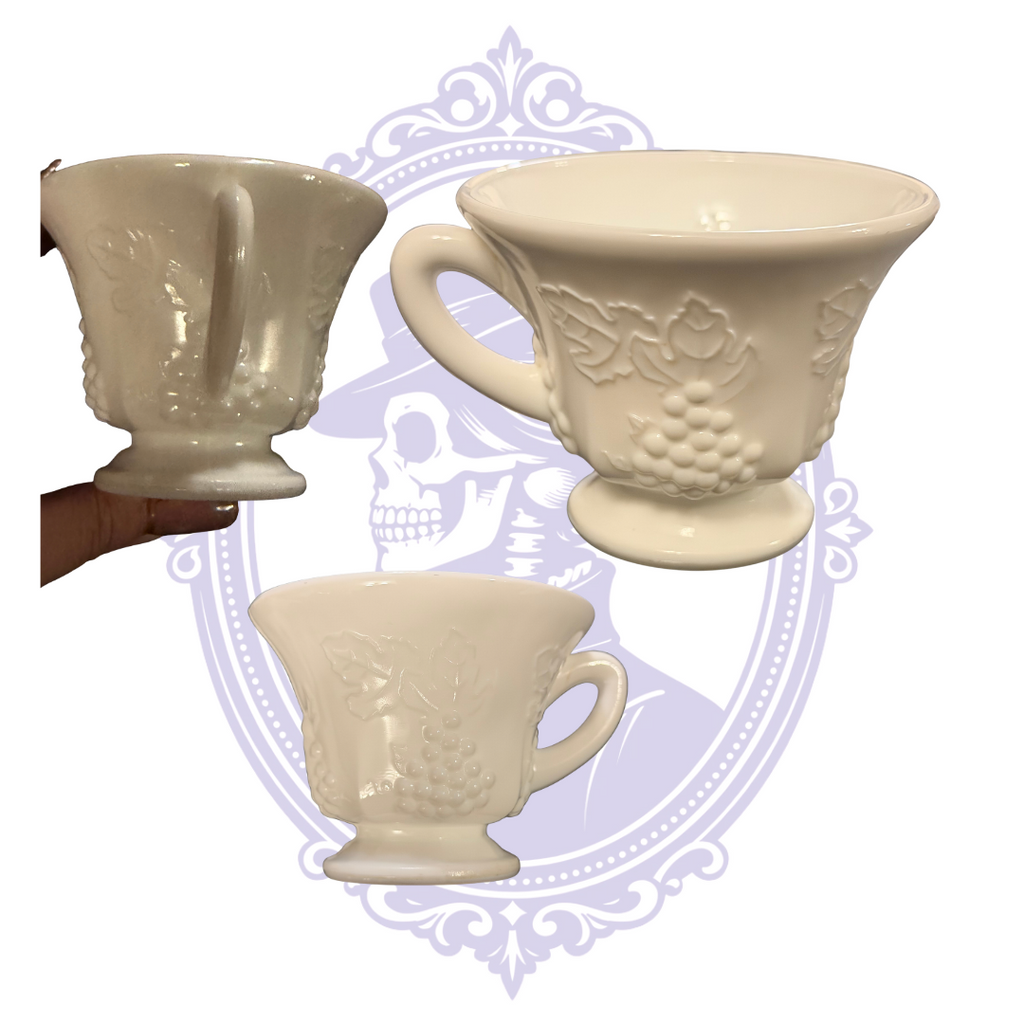 Three views of a Colony Harvest footed milk glass luncheon cup with grape and leaf relief.