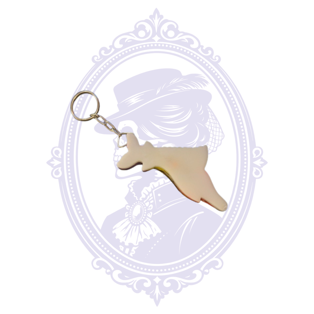 Back of Cozumel Mexico fish souvenir keychain showing cream-colored reverse and metal key ring.