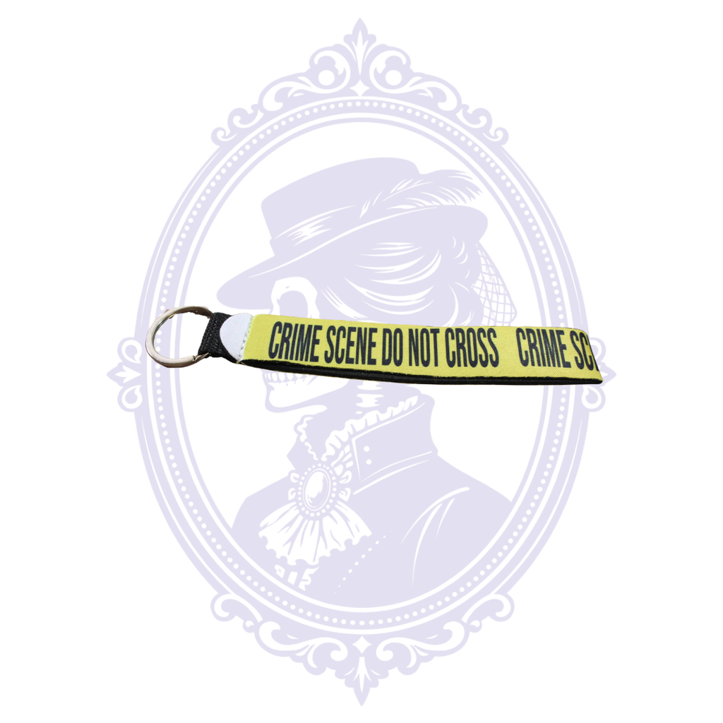 Yellow Crime Scene Do Not Cross neoprene wristlet keychain with black lettering and metal key ring