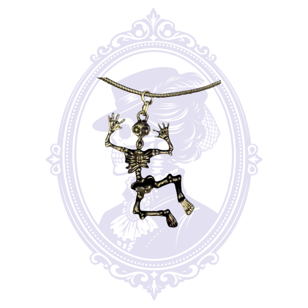 Cupboard Crafted black articulated skeleton pendant with movable arms and legs displayed against the Mrs. Bones cameo background.