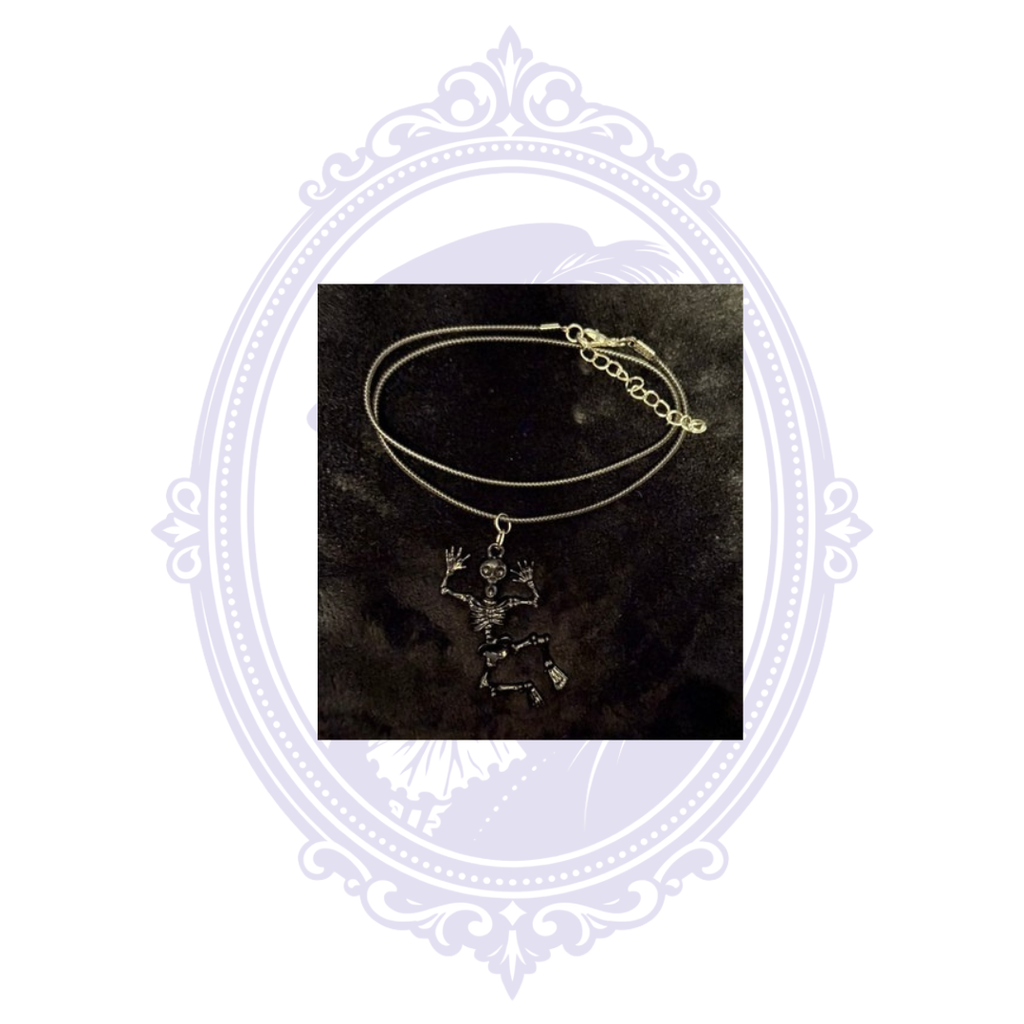 Black articulated skeleton pendant necklace shown on a black background with adjustable cord and extension chain.