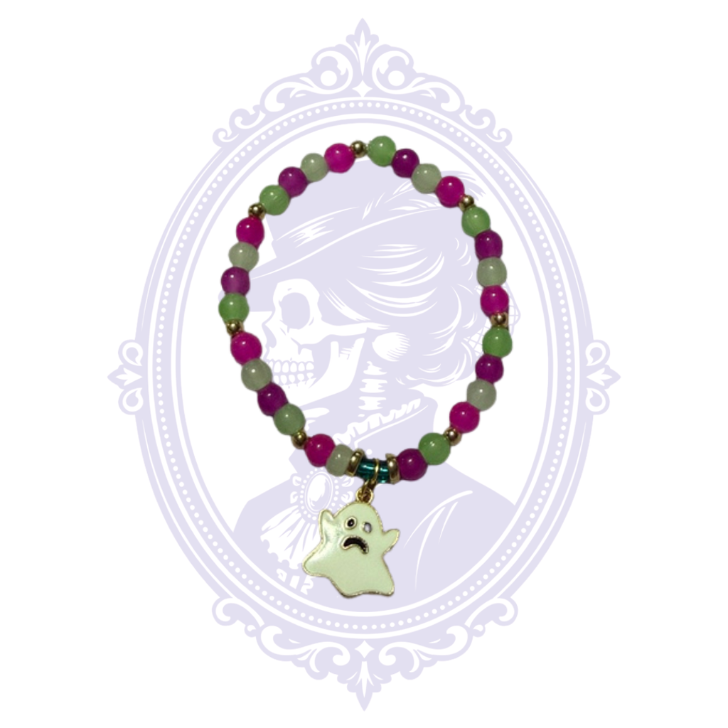 Hand-assembled purple and green glass bead bracelet with gold-tone spacers and pale ghost charm, shown from a slightly different angle.