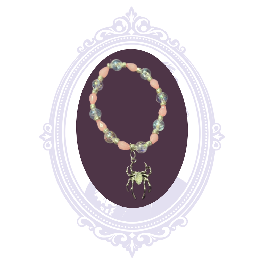 Pink and iridescent beaded stretch bracelet with silver-tone accents and dangling spider charm, hand-assembled by Mrs. Bones.