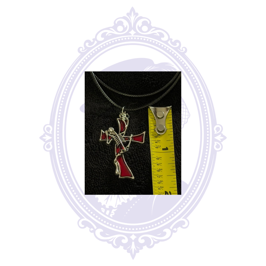 Skeleton guitarist pendant necklace shown beside measuring tape for approximate size reference.