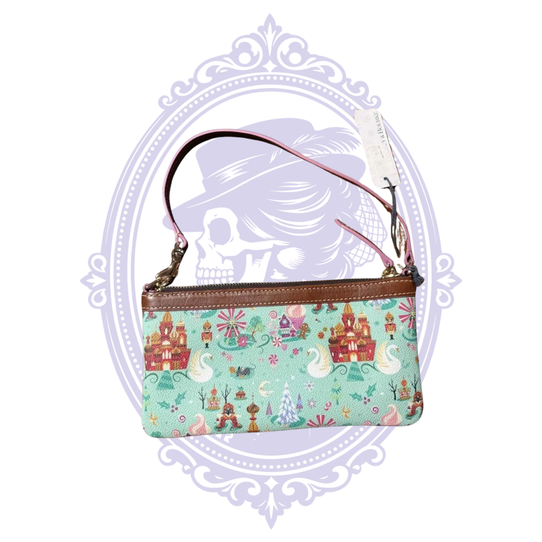 Front view of mint green Disney Dooney and Bourke Nutcracker wristlet with Follow the Dream lettering