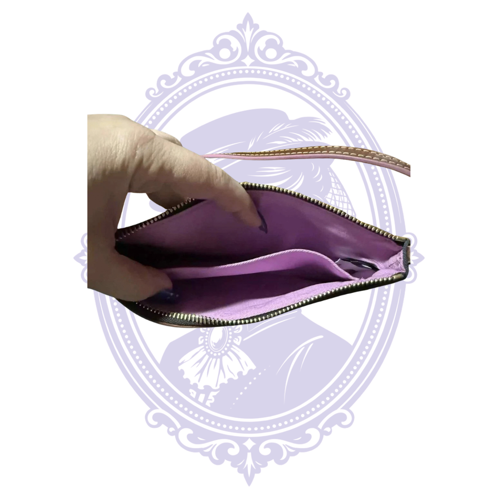 Open wristlet showing purple fabric lining and slip pocket