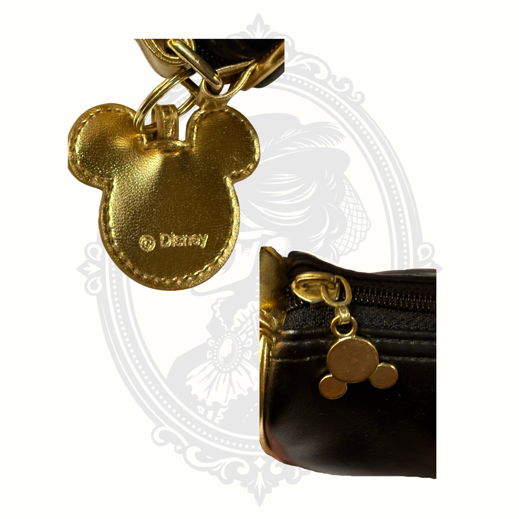 Close-up of gold Mickey Mouse shaped zipper charm on Disney wristlet purse