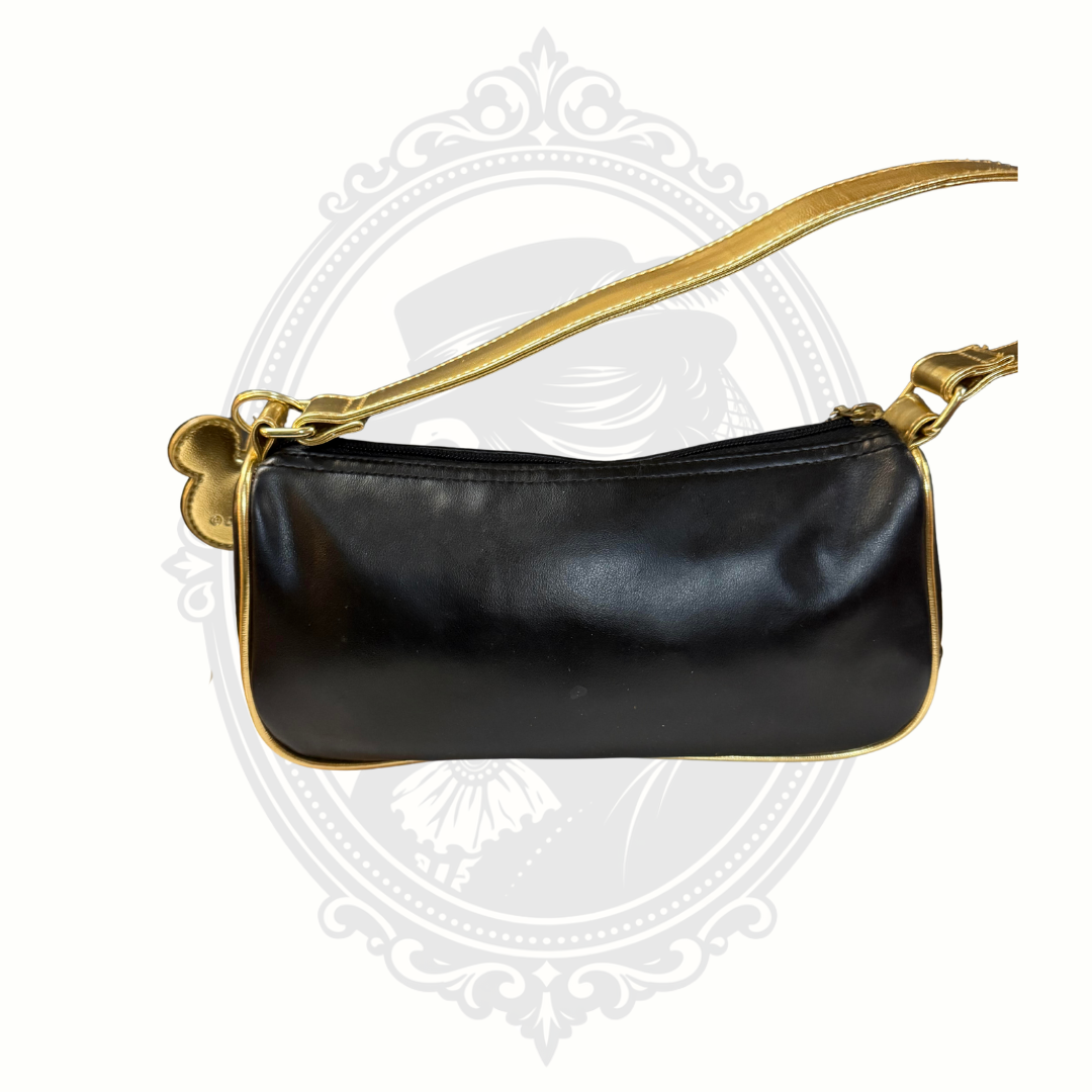 Back view of Disney black wristlet purse with gold trim and wrist strap