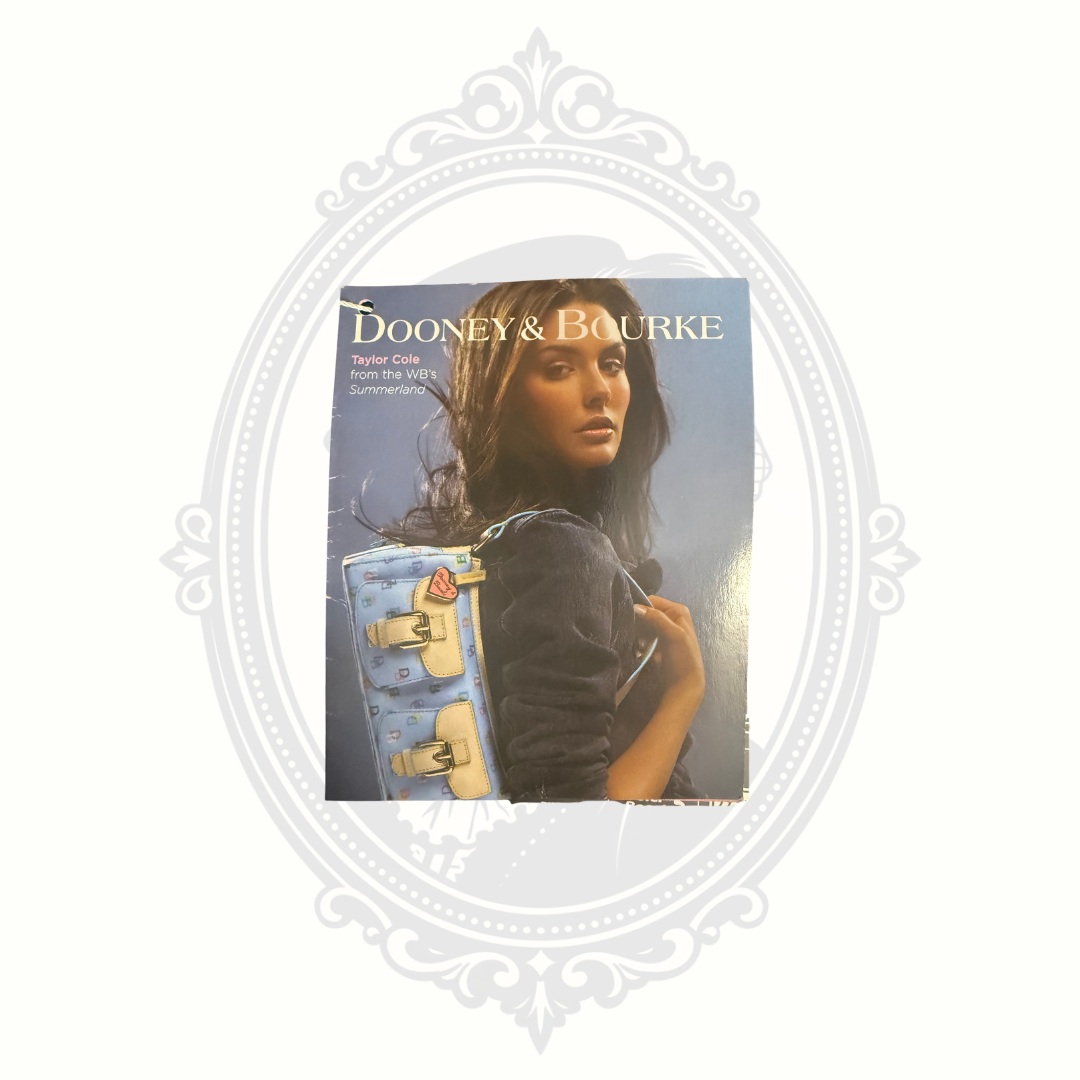 Original Dooney & Bourke retail tag showing model WE20 BL flap wristlet and price