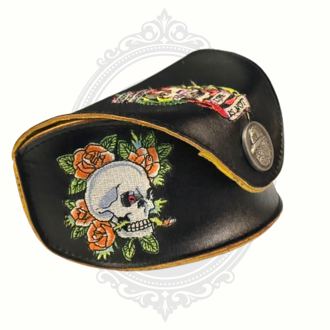 Black Ed Hardy leather sunglasses case with skull and floral design on a white background