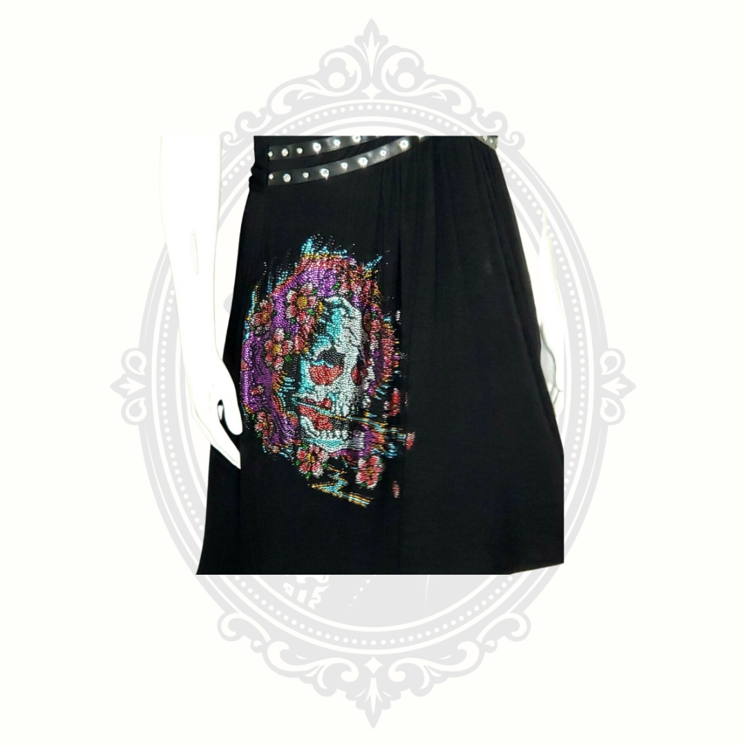 Front graphic detail of rhinestone skull artwork on black Ed Hardy dress.