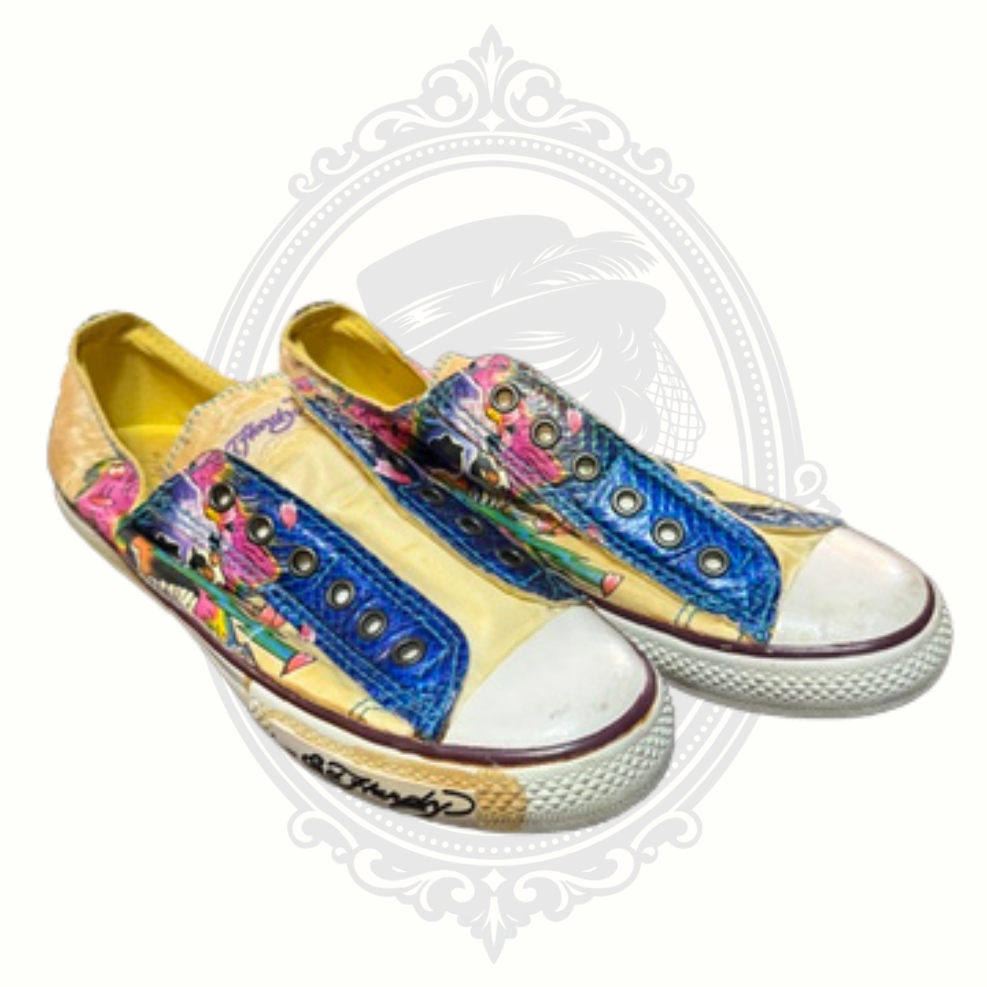 Angled front view of Ed Hardy slip-on sneakers with bold skull graphic and blue textured panels