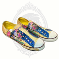 Angled view of Ed Hardy sneakers highlighting colorful skull artwork and casual slip-on style