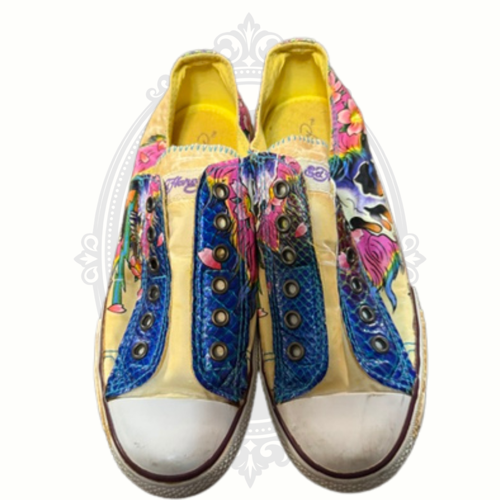 Front view of Ed Hardy sneakers with white rubber toe caps and vivid skull design